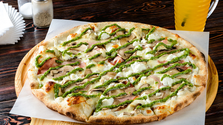 Pizza topped with pesto