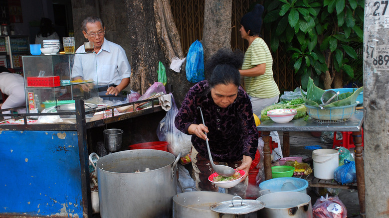 woman selling pho on the street