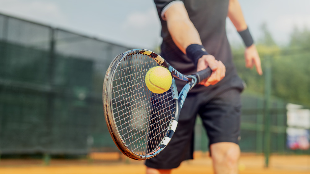 Tennis racket hits ball