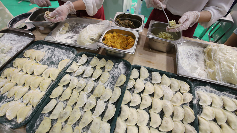 Trays of pierogi being made