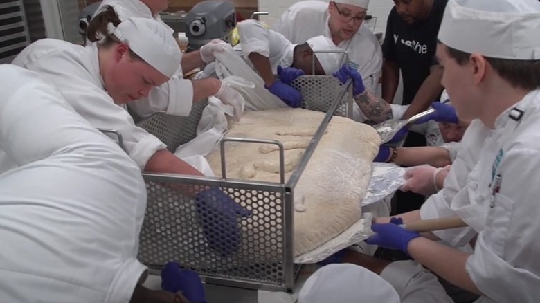 Chefs preparing enormous pierogi for cooking