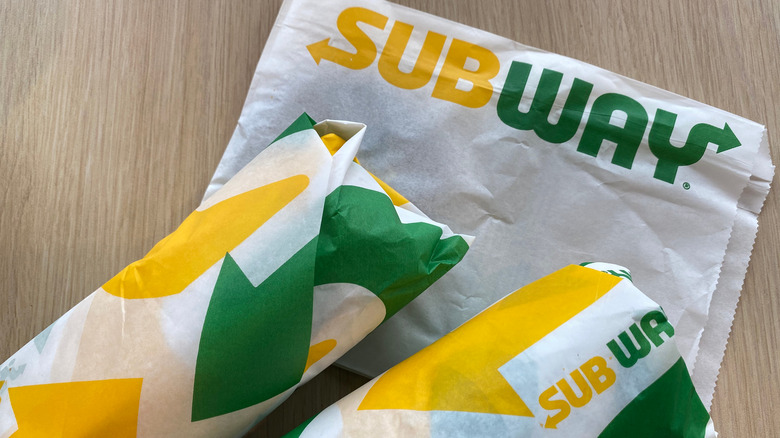 Wrapped Subway sandwiches on table