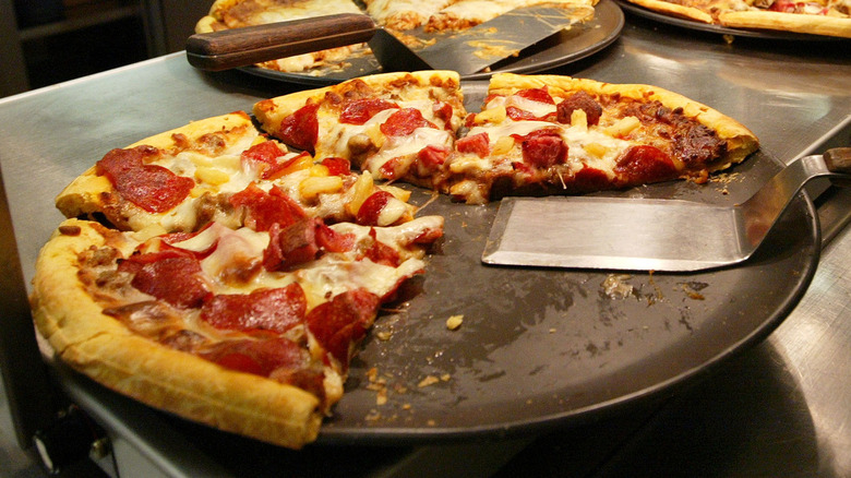 Pizza on a platter with spatula