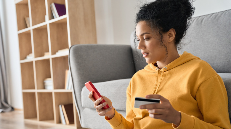 Woman with phone and card