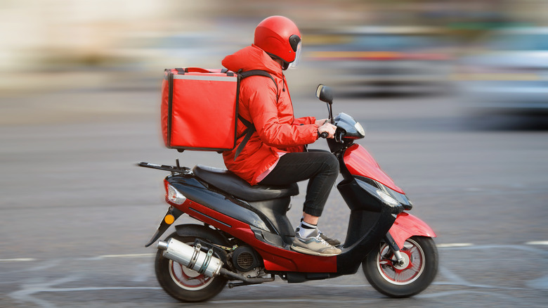 Food delivery driver on scooter