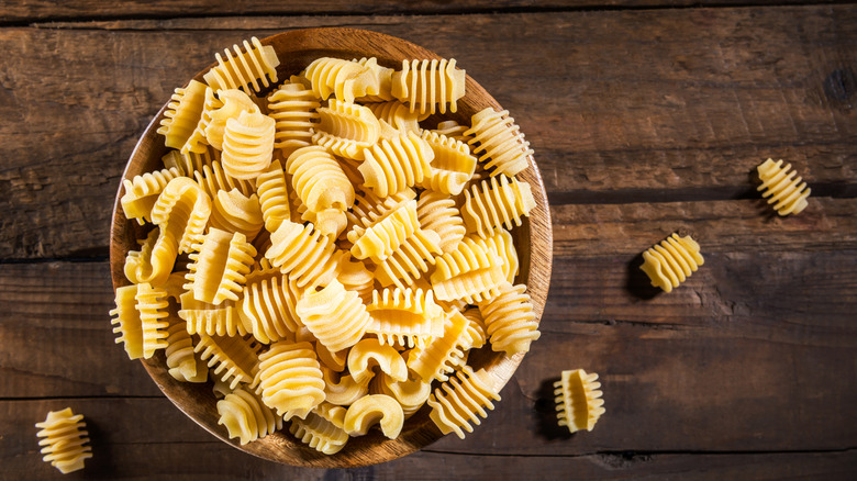 raw radiatori pasta in a wooden bowl