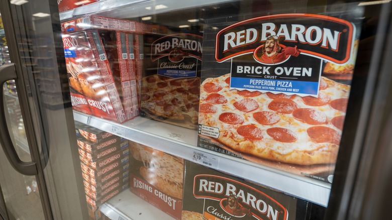 Frozen pizza brands including Red Baron in a supermarket freezer