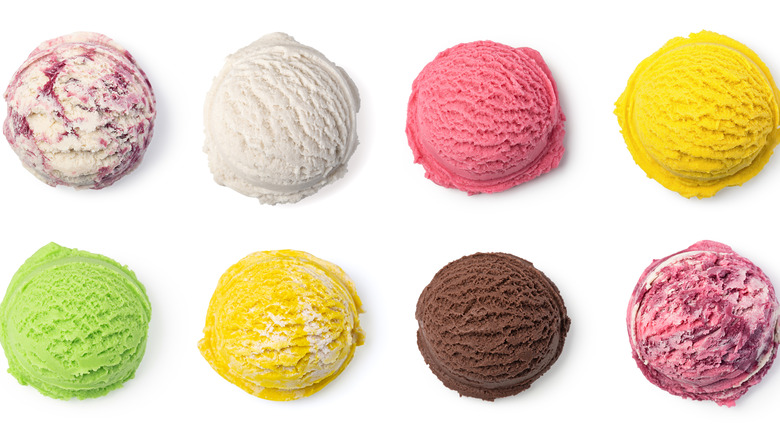Eight scoops of various flavors of ice cream on a white background