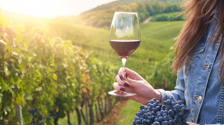 female holds a glass of wine