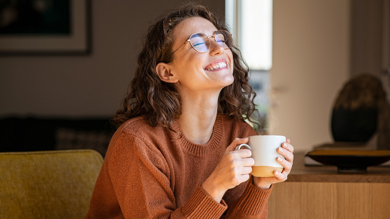 Woman with tea mug smiling