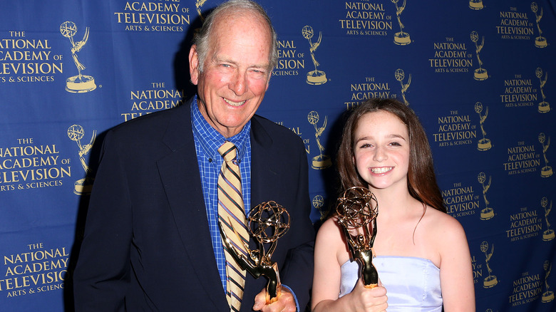 Russ Morash and Hayley Faith Negrin post with their Emmys.