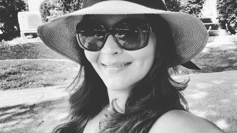 Saba Wahid sporting sunglasses and a hat