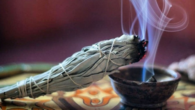 Lit smudging sage and bowl