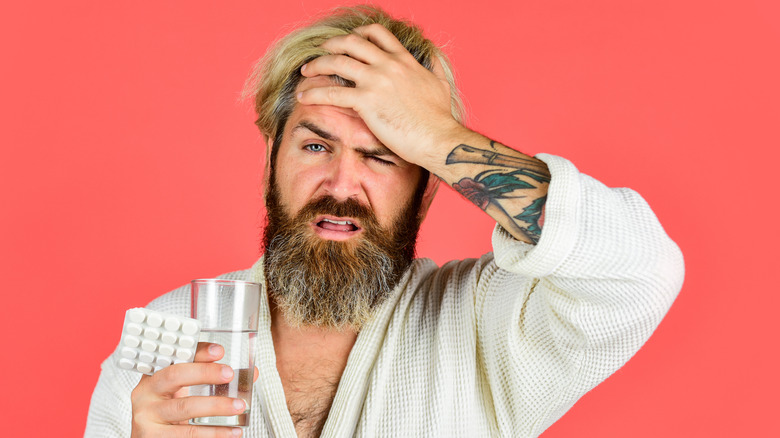 tattooed bearded man with hangover