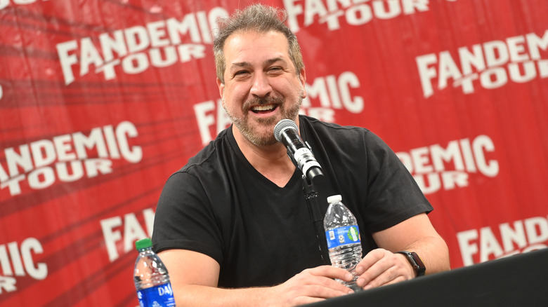 Joey Fatone sitting at a table smiling