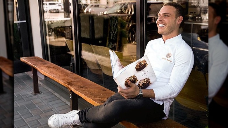 Amaury Guichon laughing with book