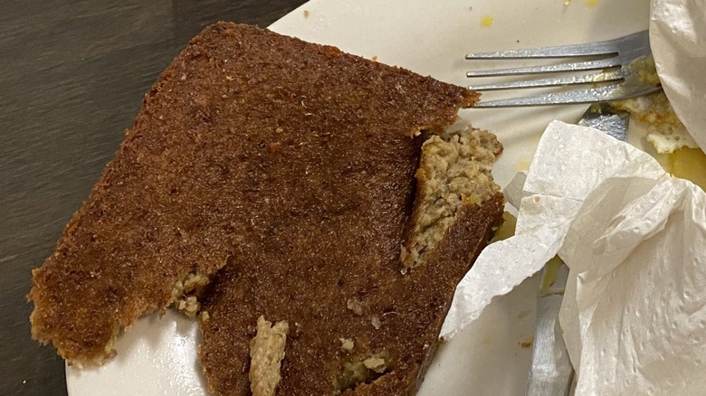 Crispy top layer of scrapple with soft insides on white plate