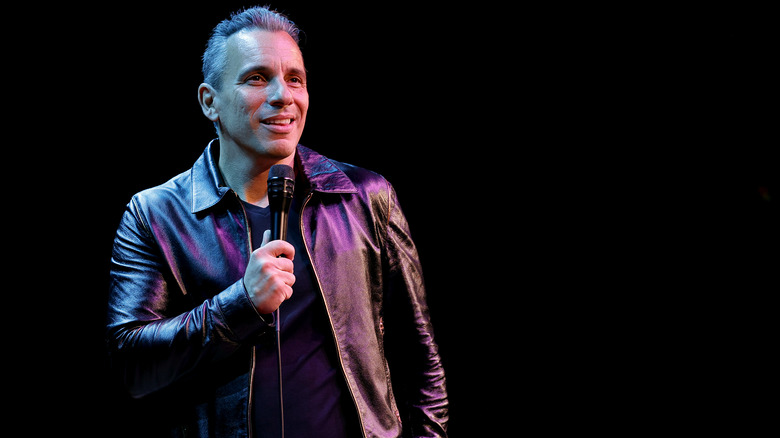 Sebastian Maniscalco on stage with microphone