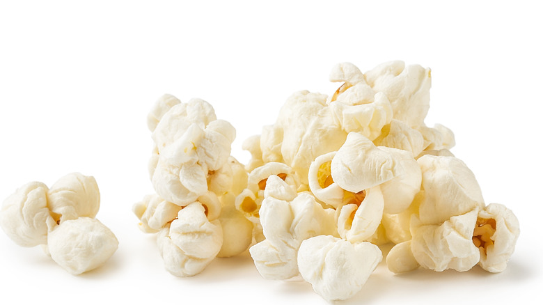 Pieces of popcorn on a white background