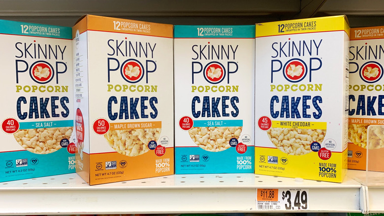 Boxes of SkinnyPop popcorn cakes on a shelf