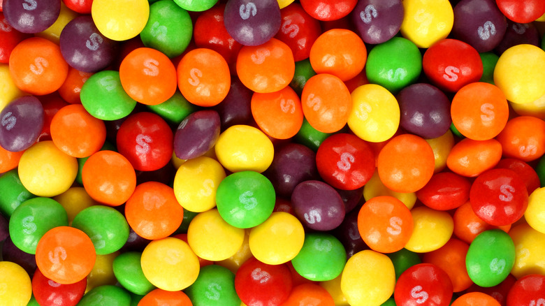 Big pile of original Skittles in every flavor and color