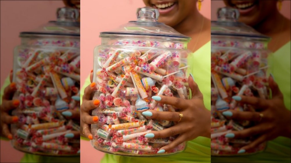 Holding jar of Smarties