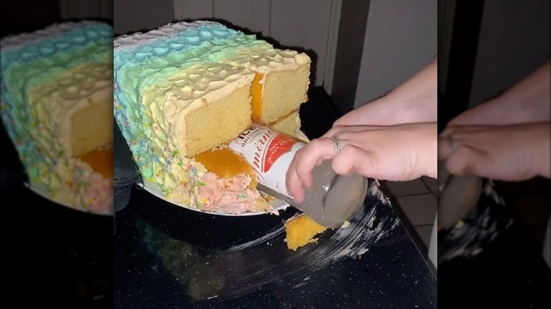 hand pulling a smirnoff ice out of cake