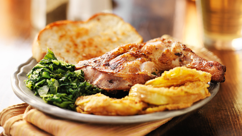 Dinner plate with chicken, collards and bread