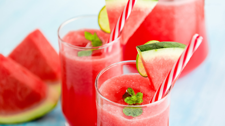 Red watermelon drink with striped straw