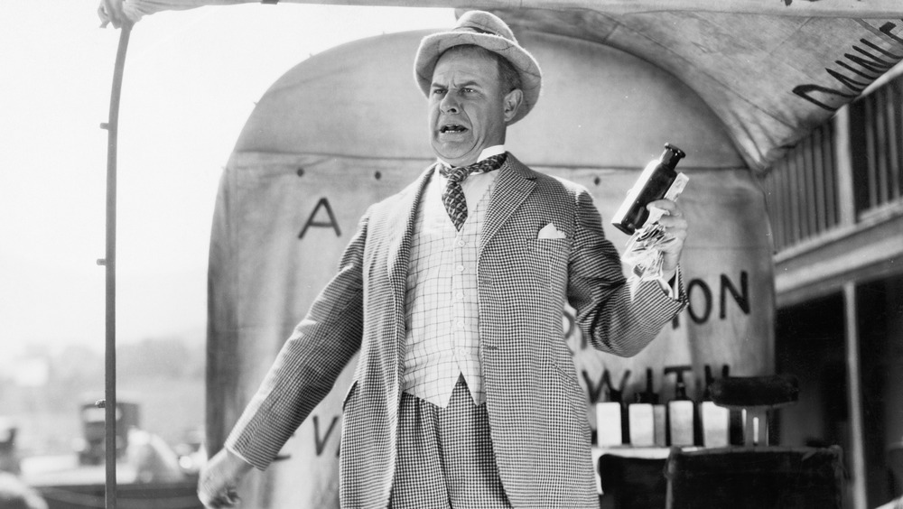 A man selling elixirs in an old photograph