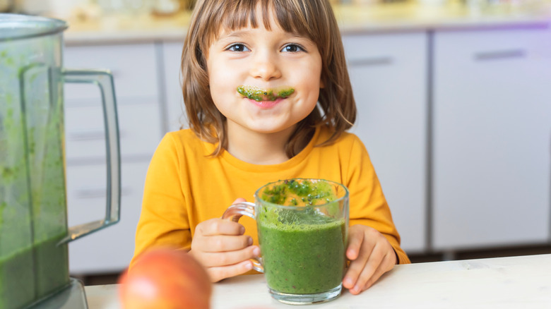 child with spinach smoothie