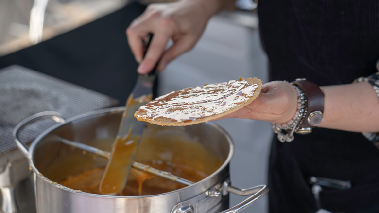 spatula spreading syrup on cookie