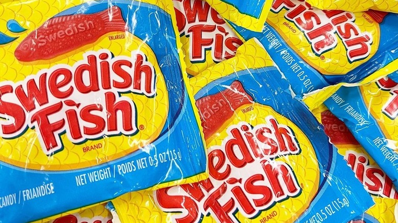 close up of a pile of snack size bags of Swedish Fish candies