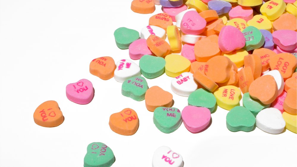 conversation hearts spilling on white background