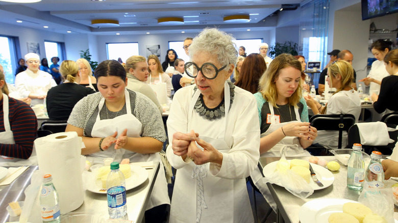 Sylvia Weinstock next to other chefs in white