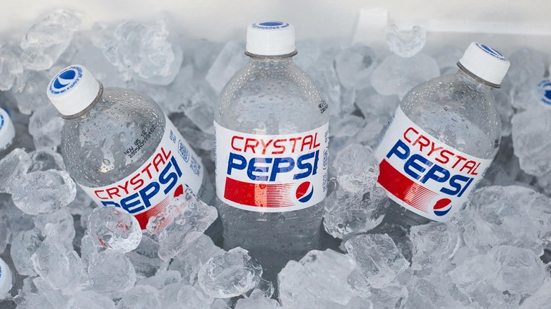 three bottles of crystal pepsi on ice