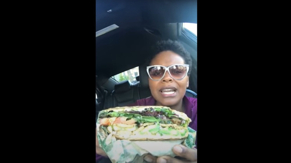 Tabitha Brown holding vegan wrap