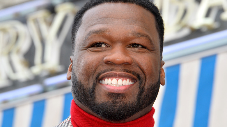 50 Cent smiling turtleneck