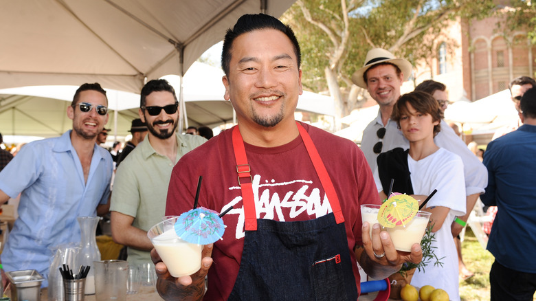 chef roy choi holding drinks with umbrellas in them