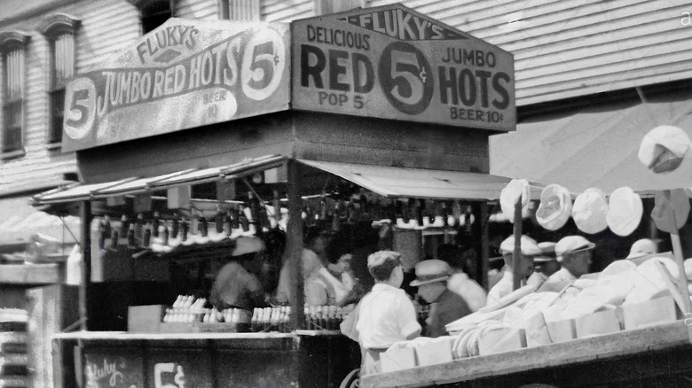 vintage black and white photo of Fluky's hot dog cart during the 1930s, selling jumbo red hots for 5 cents