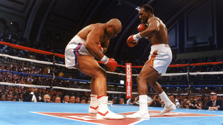 Evander George Foreman (left) and Evander Holyfield compete for the WBC, WBA, IBF Heavyweight Titles, in a bout schedule for twelve rounds at the Trump Plaza Convention Center on April 19, 1991 in Atlantic City, New Jersey.  Holyfield and George Foreman boxing