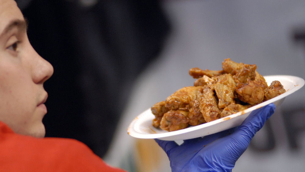 A staffer carrying wings at the Philadelphia Wing Bowl