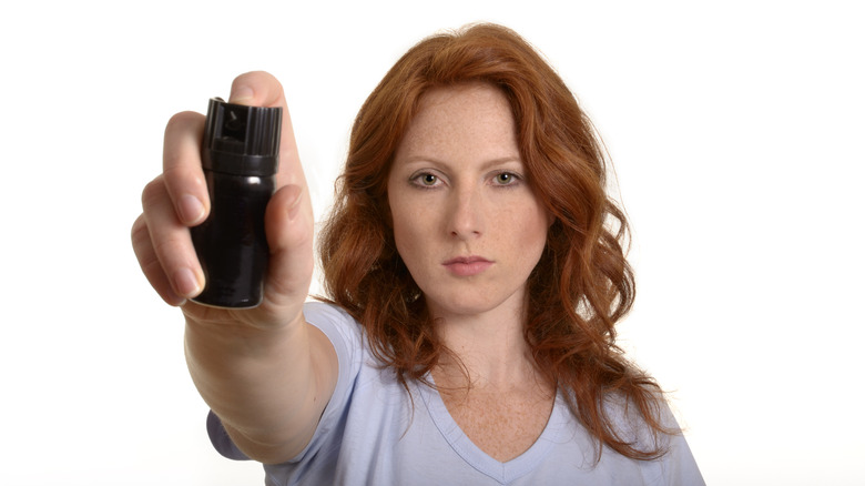 Woman holding pepper spray canister