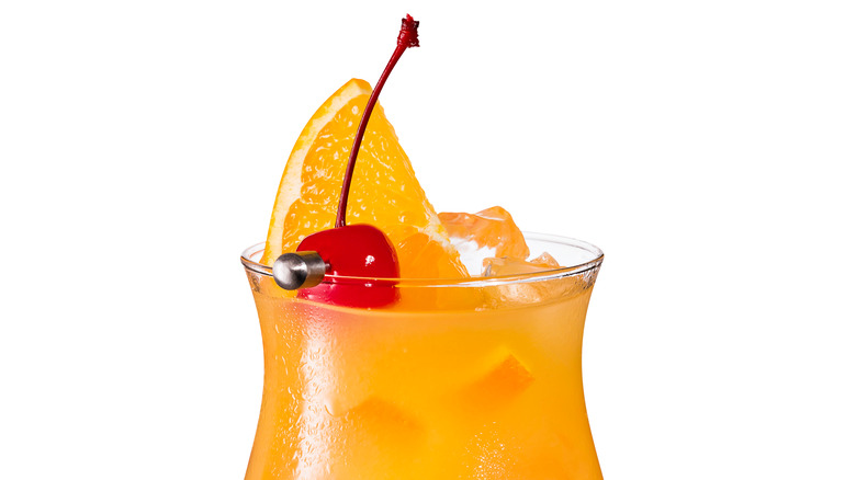 orange and red cocktail with fruit garnish