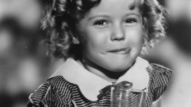 young shirley temple having a drink