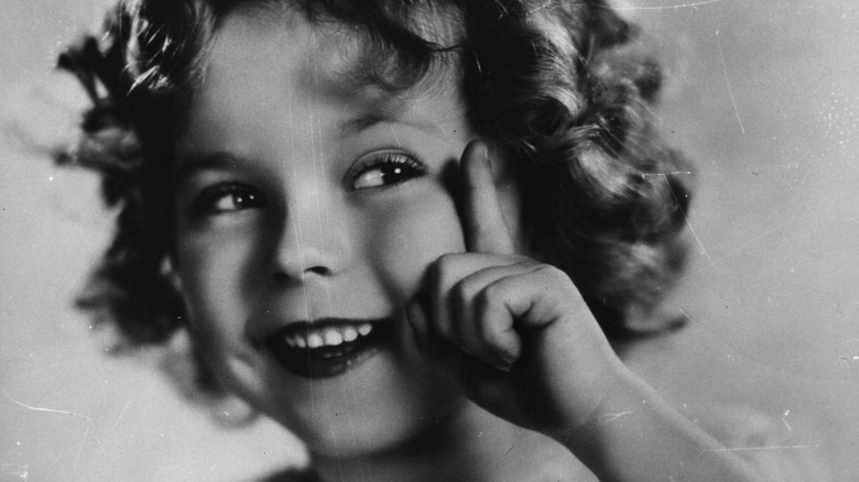 young shirley temple pointing up