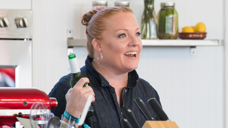 Side view of Tiffani Faison holding a beer