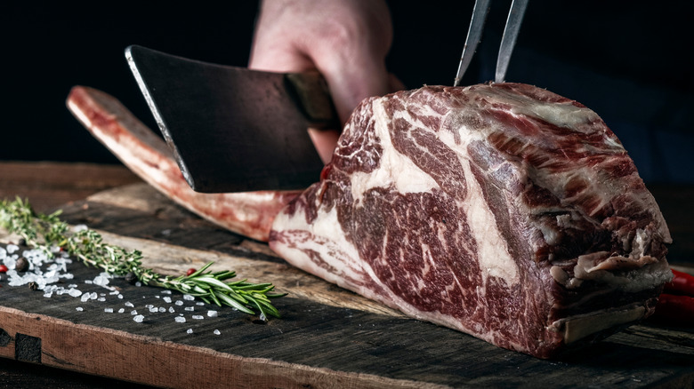 Tomahawk steak with butcher knife