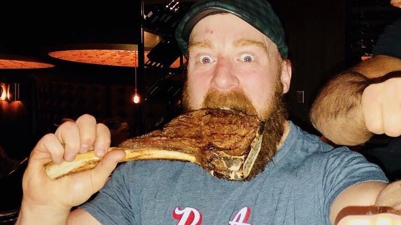 Man eats Tomahawk steak