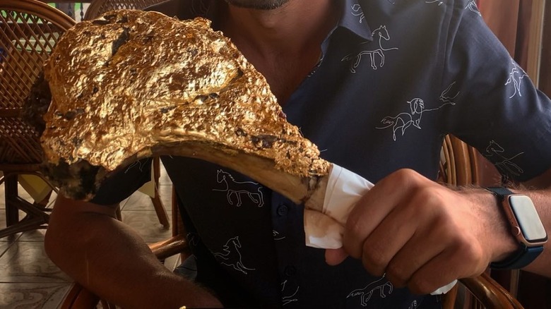 Tomahawk steak wrapped in gold